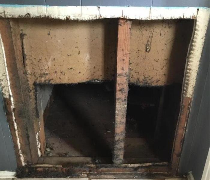 Debris covered air conditioning return duct