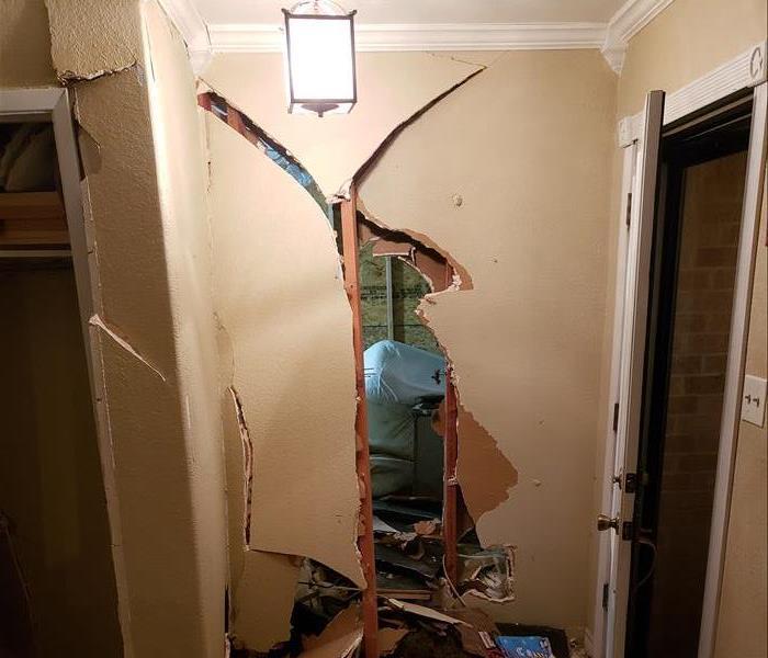 an entryway to a home with structural damage