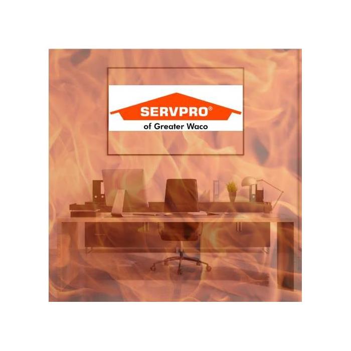 Image of an office with a fire overlay with the SERVPRO logo